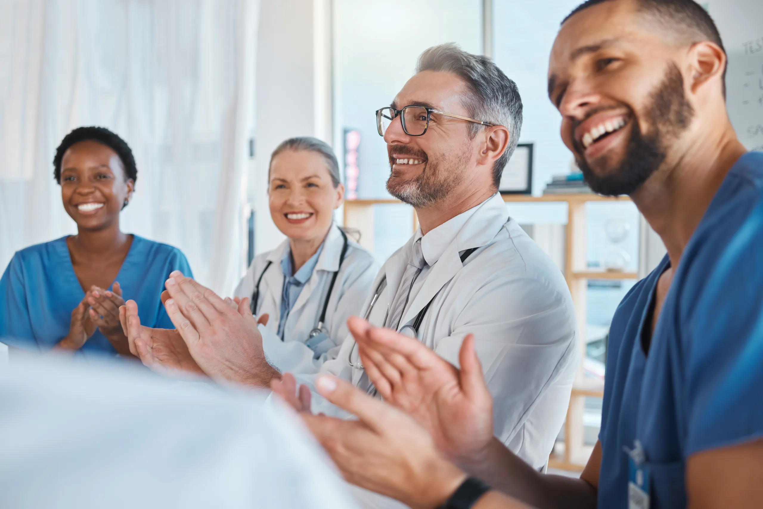 Doctors, nurses and teamwork collaboration clapping after medical presentation