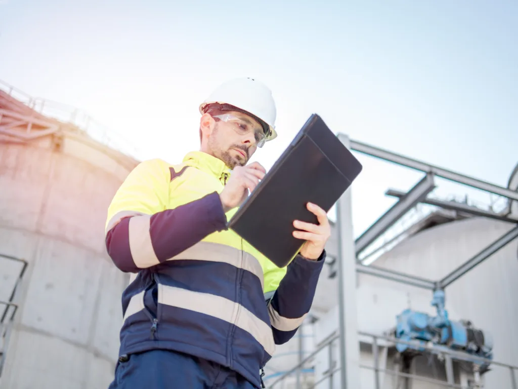 Engineer making notes on clipboard