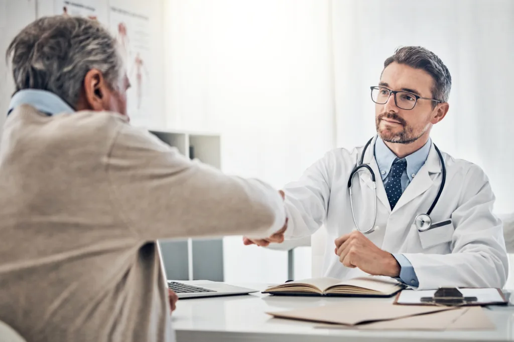 Doctor shaking hands with male patient