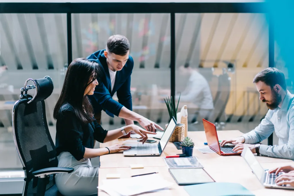 Business group working at a table on laptops