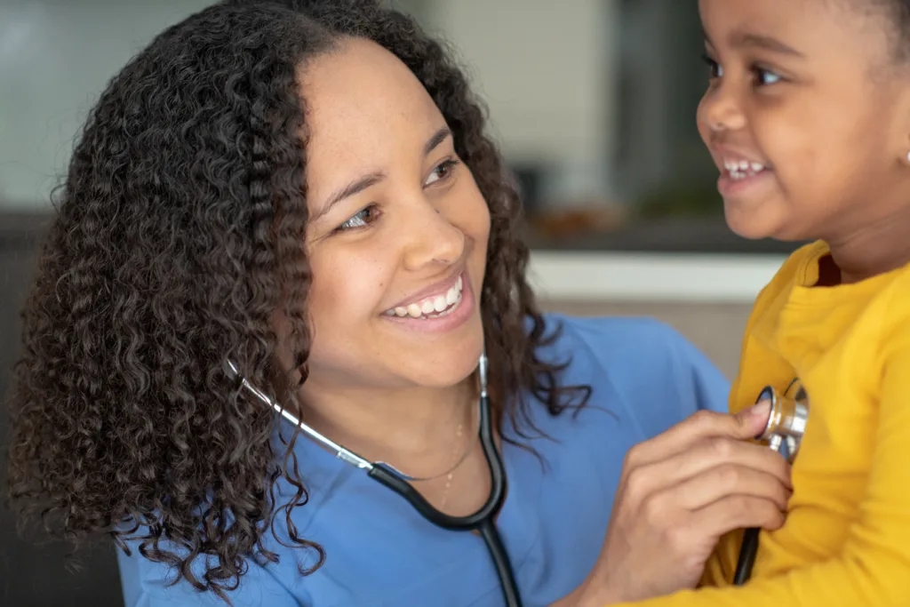 Female pediatrician with young male patient