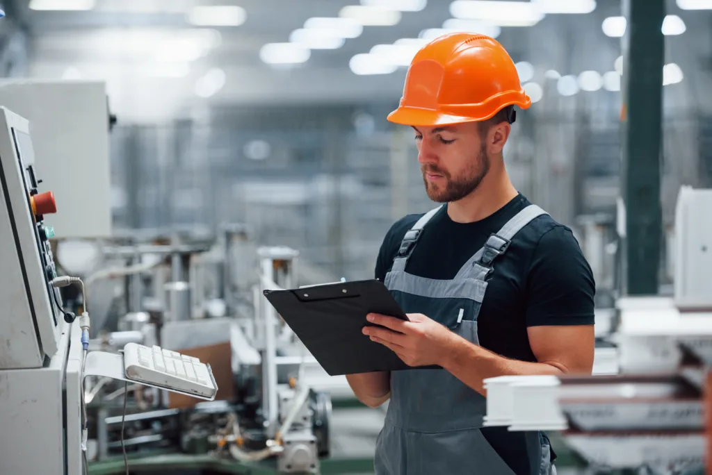 Industrial Worker making notes