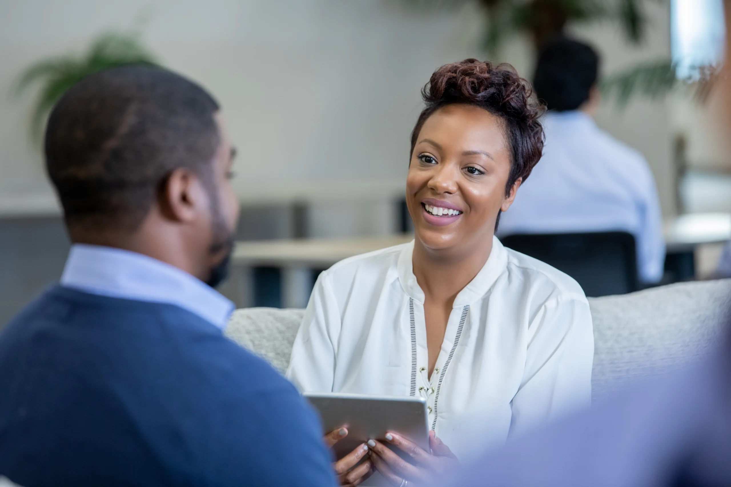 Female social worker talking with male client