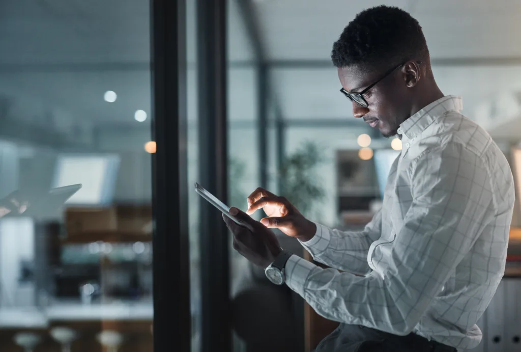 Professional looking at emails on tablet