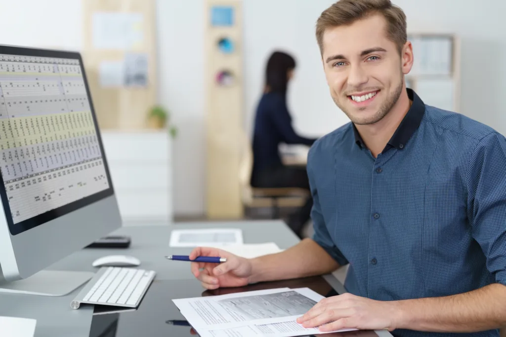 Male at computer working on spreadsheets