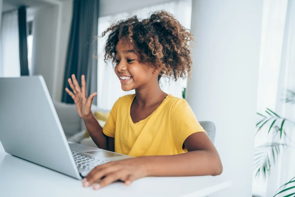 Young female student  using a laptop for video conference from home