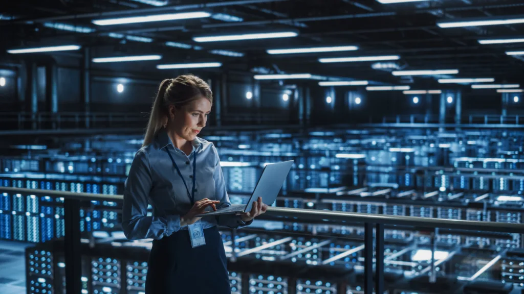 Data Center Female IT Specialist Using Laptop. 