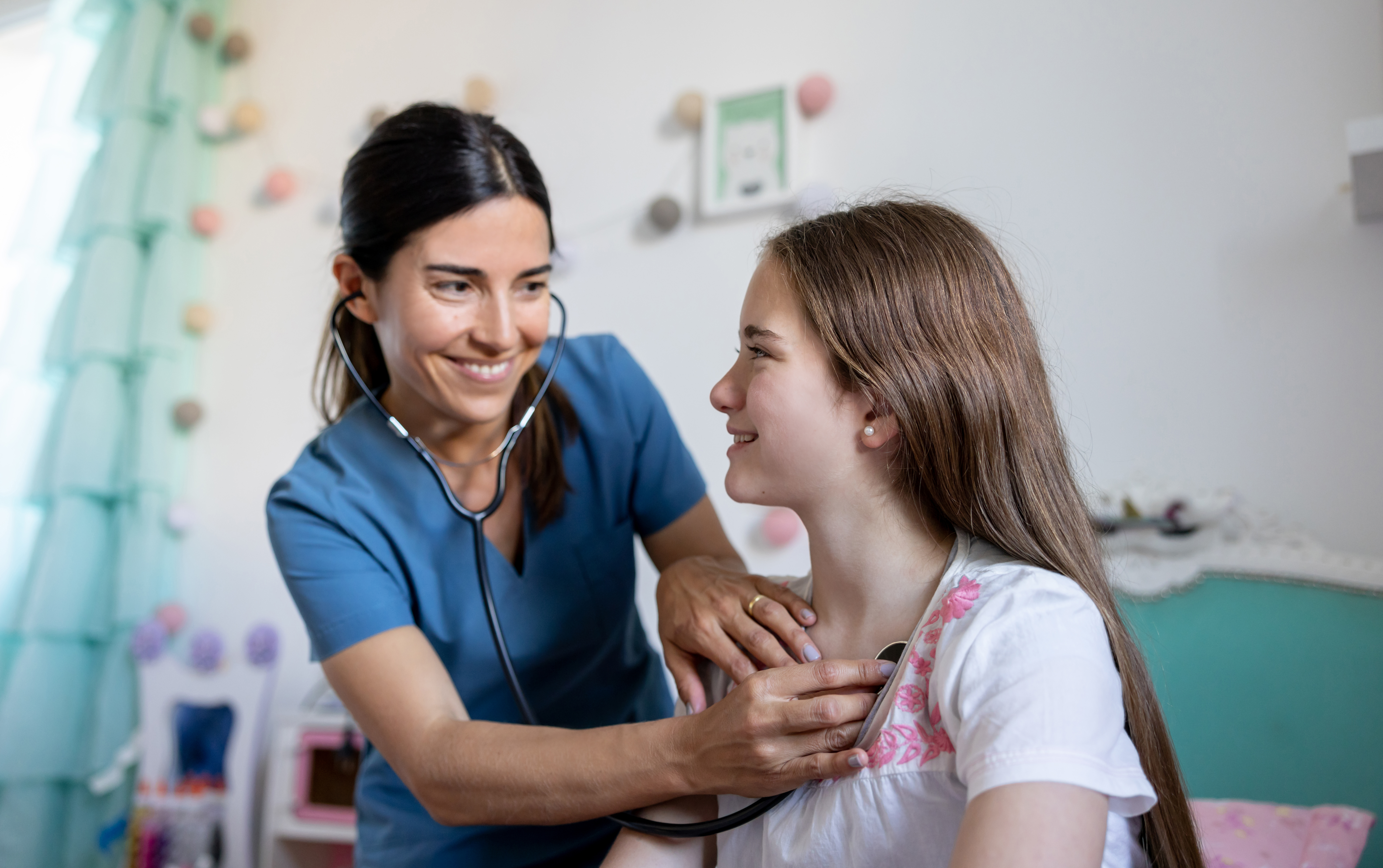 female doctor performing a medical exam on a young girl during a house call