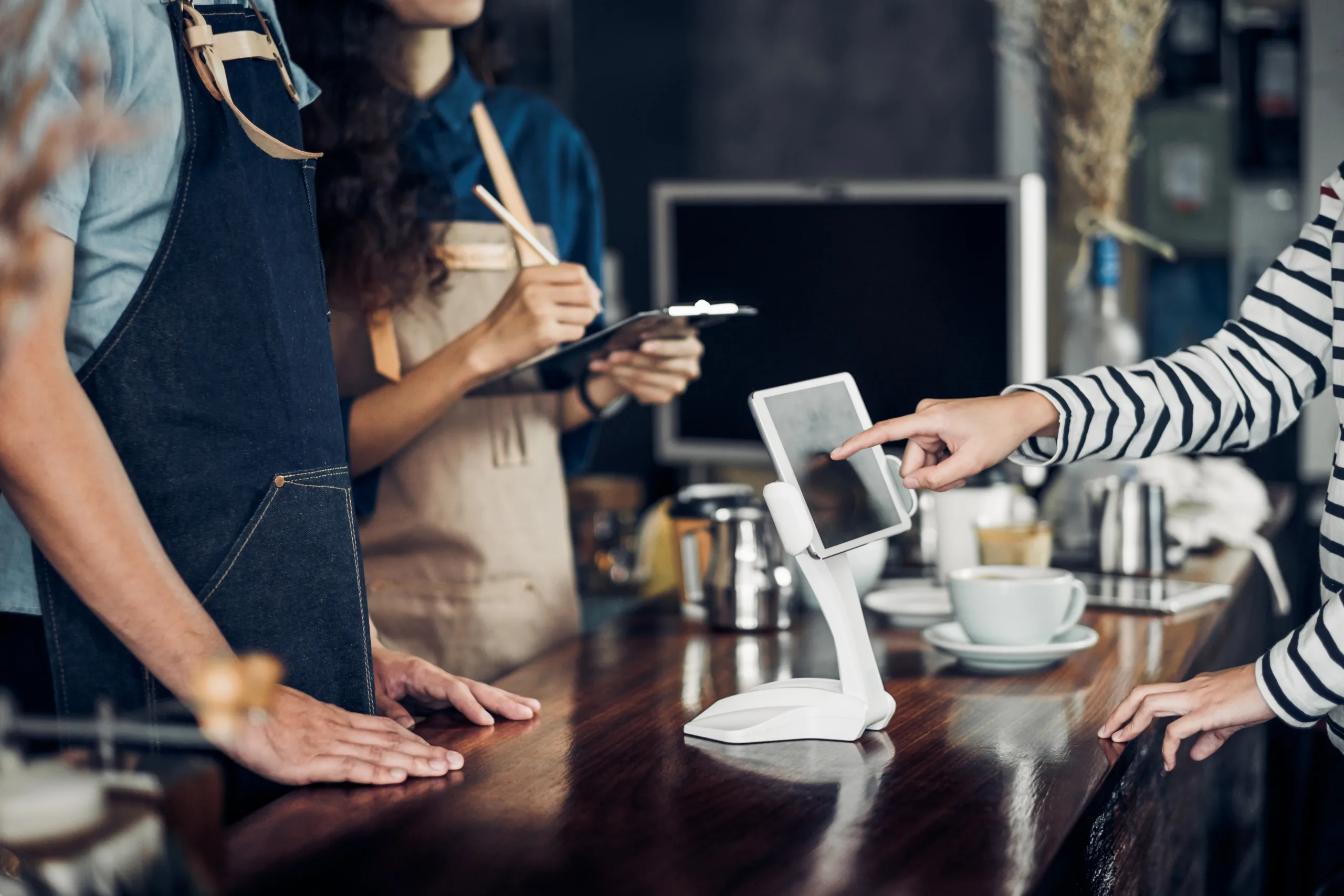 Customer at a bakery paying for their items on an iPad