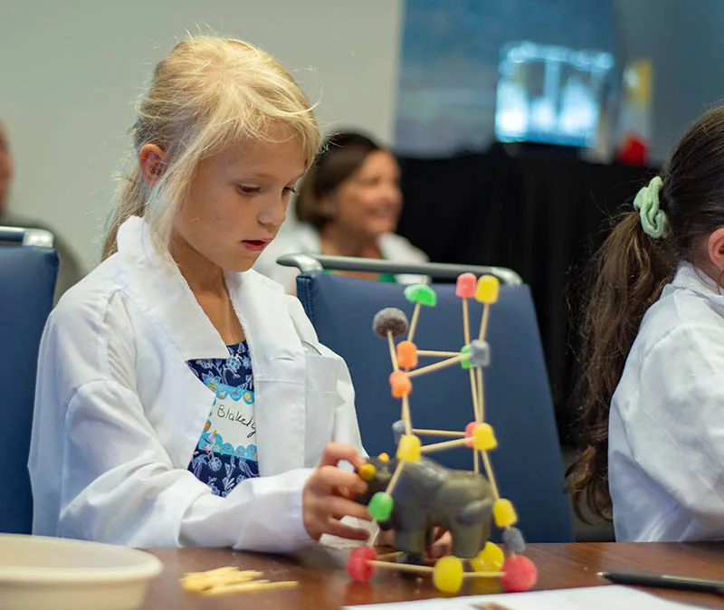 young girl performing stem activities at kids day event